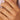 A close-up image of a person's hand wearing a 9ct gold diamond engagement ring with nibbled edges.