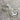A pair of silver hoop earrings with etched patterns, displayed against a wooden background.