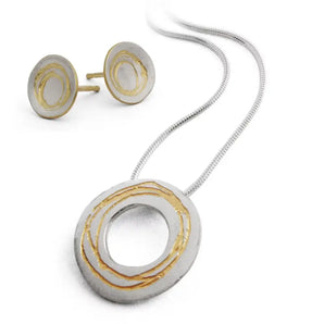 A sterling silver necklace and earring set with etched geometric patterns, featuring gold plating and a satin finish. The pendant is attached to a silver snake chain and there are accompanying round earrings.