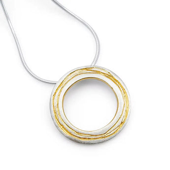 A sterling silver necklace with a gold detailed etched pendant, threaded on a snake chain through a tube on the reverse.