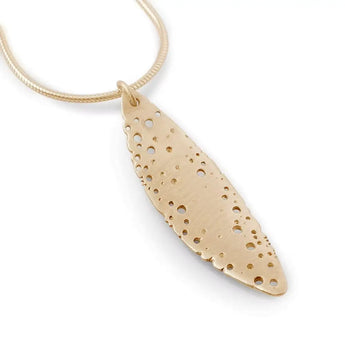 A gold leaf-shaped necklace pendant with a pattern of holes, attached to a gold snake chain.