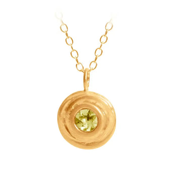 A gold peridot small swirl pendant on a gold chain, showcasing a circular design with the gemstone in the center.