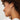 A side profile of a woman wearing long silver strand earrings with a satin finish.