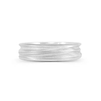 A silver ring with a textured surface designed to resemble windswept sand dunes, with a polished and smooth interior.