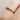 Gold ring with colourful birthstone gemstones on a finger against a neutral background