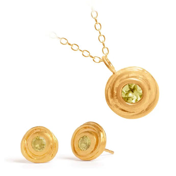 A gold plated sterling silver pendant necklace and earrings set featuring peridot gemstones, presented against a white background.