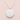 A sterling silver round pendant necklace with a textured matte finish and a serrated edge, shown on a delicate silver chain against a soft pink background. The bottom of the pendant features a sterling silver hallmark stamp.