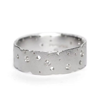A sterling silver diamond ring with a frosted finish and scattered brilliant cut diamond stones, displayed against a white background.