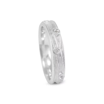 A slim silver ring with scattered diamonds set within a textured band, showing a polished finish.