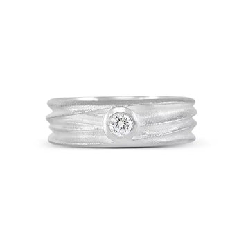 A sterling silver solitaire ring with a textured band and a central sparkling stone, part of the Dune Collection.