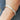 A silver bangle bracelet with a textured matte finish worn on a person's wrist.