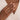 Hand wearing a diamond gold ring on a neutral background handmade in Birmingham