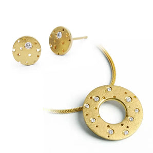 A set of 18ct gold jewelry including a necklace with a circular pendant adorned with sparkling diamonds, and a pair of earrings, both featuring a frosted finish.