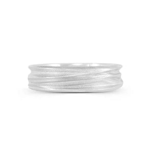 A silver ring with a textured surface designed to resemble windswept sand dunes, with a polished and smooth interior.