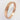 A 9ct rose gold wedding ring with nibbled edges on a white background.