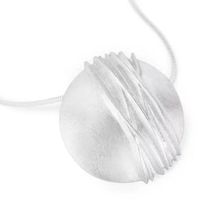 A silver necklace with a textured satin finish pod and a chain threaded through two discreet holes on the reverse, fastened by a contemporary T-bar style catch.