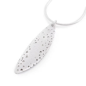 A silver leaf-shaped necklace with a pattern of holes, displayed against a white background.