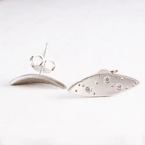 A pair of silver earrings featuring a leaf pattern with three brilliant cut diamonds, set against a white background.