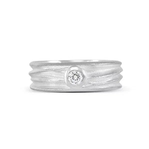 A sterling silver solitaire ring with a textured band and a central sparkling stone, part of the Dune Collection.