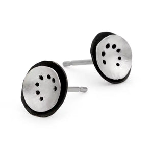 A pair of silver-colored earrings with a spiral pattern and multiple holes arranged in a dome shape, displayed against a white background.