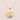 A gold pendant necklace featuring a textured, matte circular disc pendant wrapped with three parallel metallic wire strands, suspended from a delicate gold chain against a soft, light pink background.